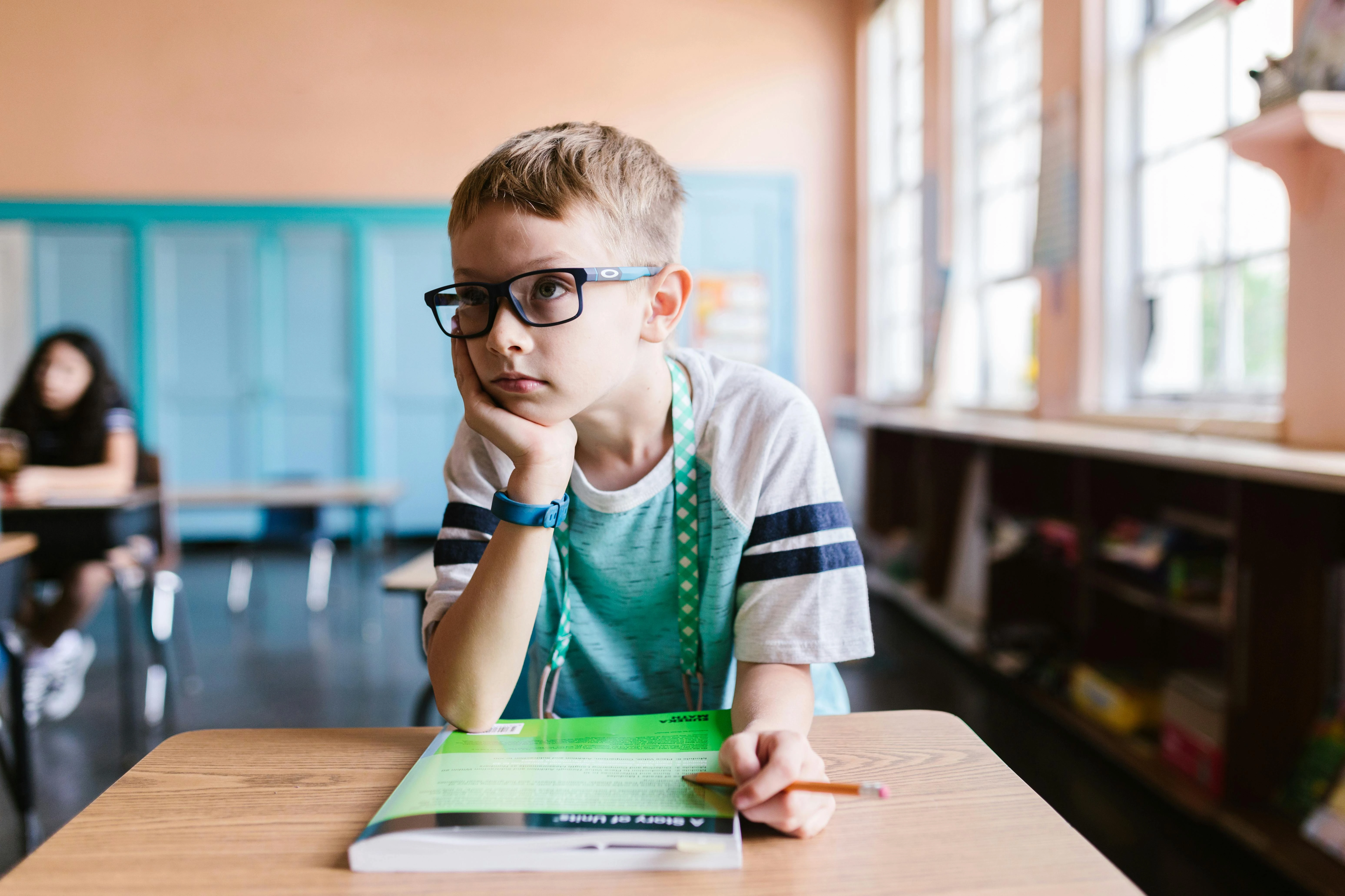 Boy with ADHD in a classroom, distracted and struggling to focus — the right IEP changes everything