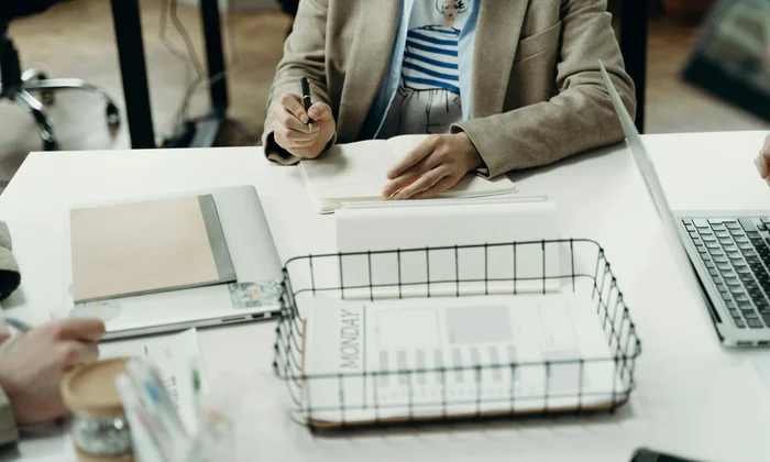 Parent writing notes preparing an IEP meeting agenda
