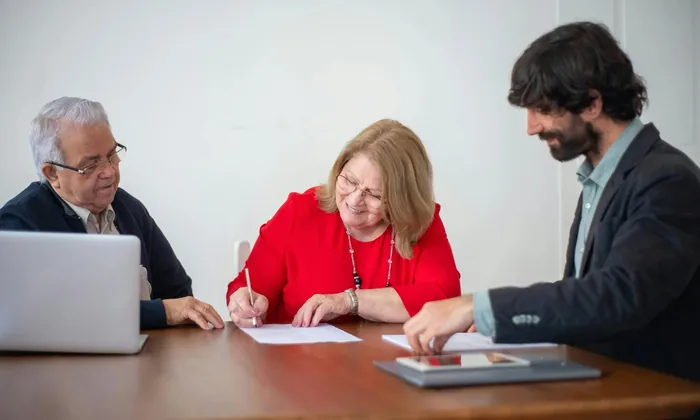 Parents at an IEP meeting table reviewing documents