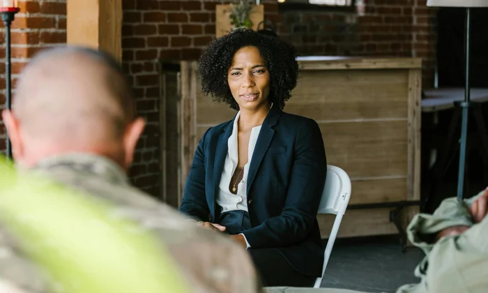 Parents and school professionals seated around a meeting table in an IEP discussion
