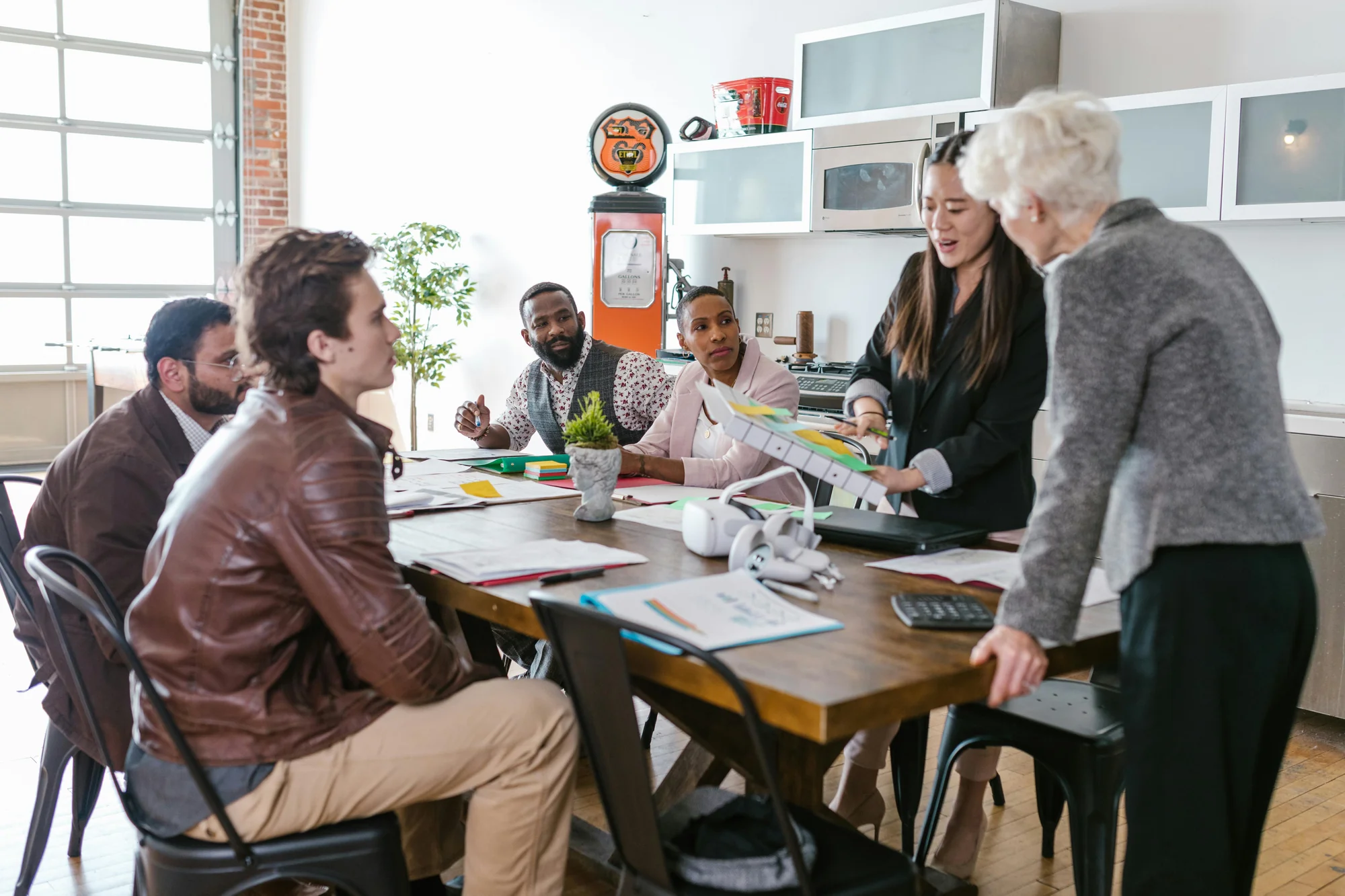 Diverse group of parents and school professionals seated around a conference table at an IEP meeting